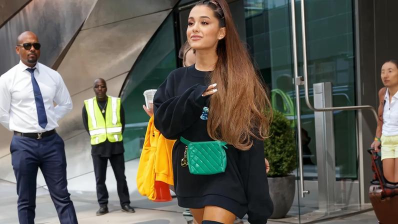 Ariana Grande sat down with Vogue to discuss her 2018 go-style of oversized sweatshirts and thigh-high boots.