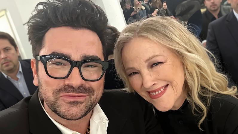 Dan Levy and Catherine O'Hara smiling together in a selfie.