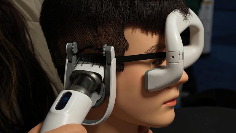 Photo of a mannequin head being "shaved" by the Glyde smart hair trimmer