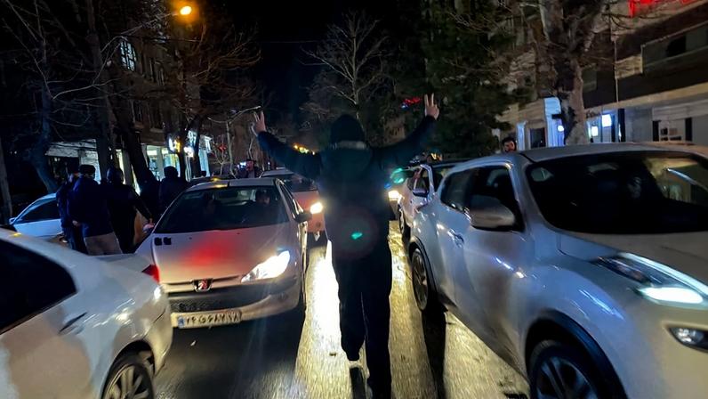 A protester flashes a victory signs as traffic slows during demonstrations in Hamedan, Iran, on Jan. 1.