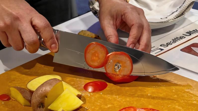 Photo of the Seattle Ultrasonics C-200 knife slicing a tomato