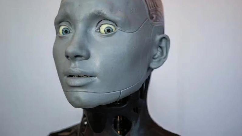 O robô humanóide com inteligência artificial Ameca observa o estande da empresa Engineered Arts durante o maior encontro mundial de robôs humanóides em Genebra, na Suíça em 2023 — Foto: Fabrice Coffrini/AFP