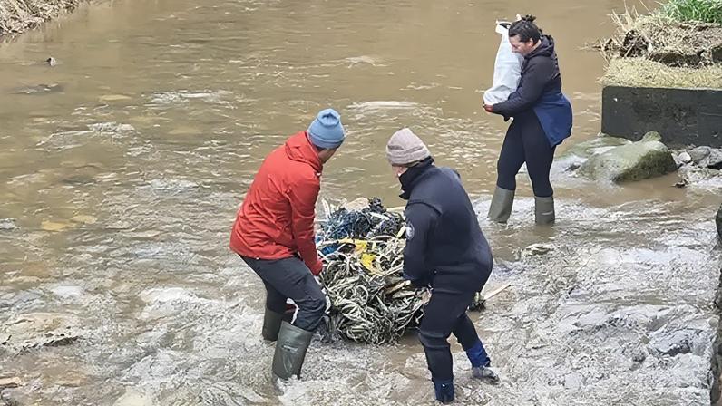 Volunteers from British Divers Marine Life Rescue clear waste plastic from Boggle Hole near Robin Hood's Bay