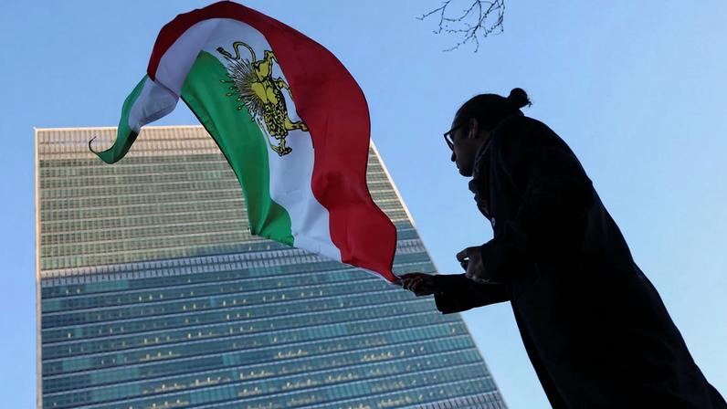 A protester waves the pre-Islamic Revolution Iranian flag outside United Nations headquarters during a U.N. Security Council meeting on Iran in New York City on Jan. 15.