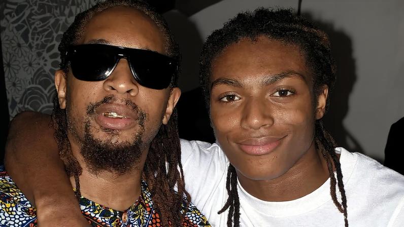 Lil Jon wearing a Baltimore Ravens beanie, sunglasses, and jacket.
