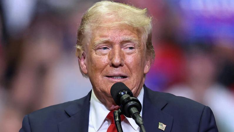 Republican presidential nominee and former U.S. President Donald Trump wears a flesh-colored bandage on his ear as he holds a campaign rally for the first time with his running mate, Republican vice presidential nominee U.S. Senator J.D. Vance (R-OH) in Grand Rapids, Michigan, U.S. July 20, 2024. REUTERS/Tom Brenner