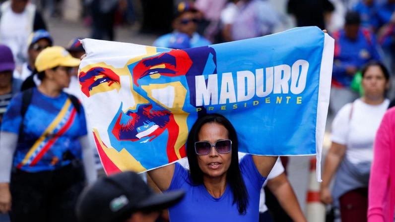 A demonstrator holds a banner as supporters of Venezuela's government rally to demand the release of ousted President Nicolas Maduro and his wife, Cilia Flores, one month after their capture by U.S. during recent U.S. strikes on the country, in Caracas, Venezuela, February 3, 2026. REUTERS/Leonardo Fernandez Viloria