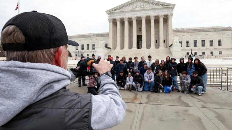 A group of visiting students have a photo taken outside the U.S. Supreme Court, where justices are expected to issue opinions in pending cases, in Washington, D.C., U.S., February 25, 2026. REUTERS/Kevin Lamarque
