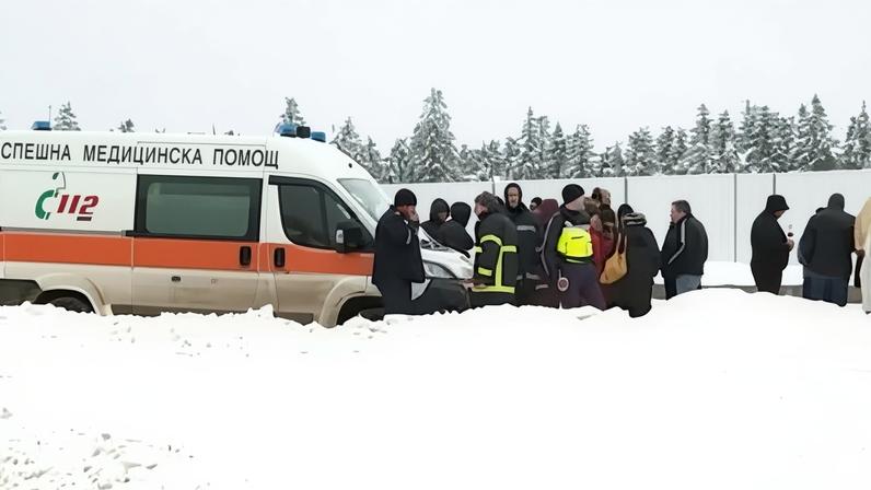 Emergency services near the Petrohan pass, where three men were found in the burned out remains of a lodge with gunshot wounds to the head.