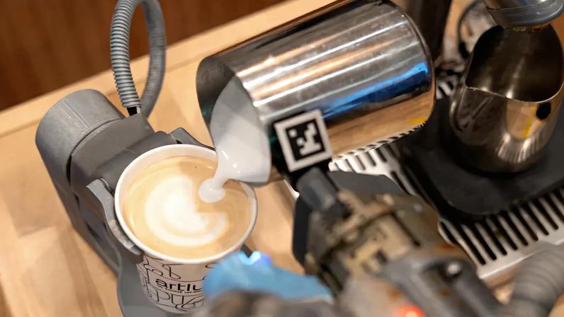 Robot barista pouring latte art