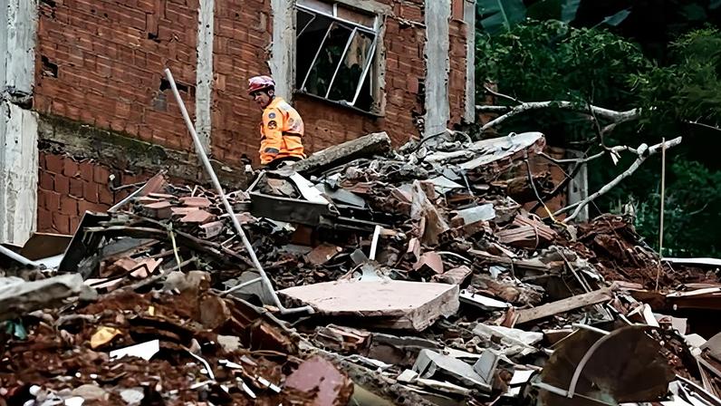 A member of the fire department carries out rescue work in an area affected by heavy rains in Juiz de Fora, Brazil, 24 February 2026.