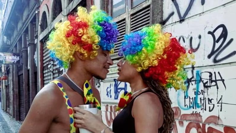 A couple dressed as clowns walk through Lapa, Rio de Janeiro, during carnival.
