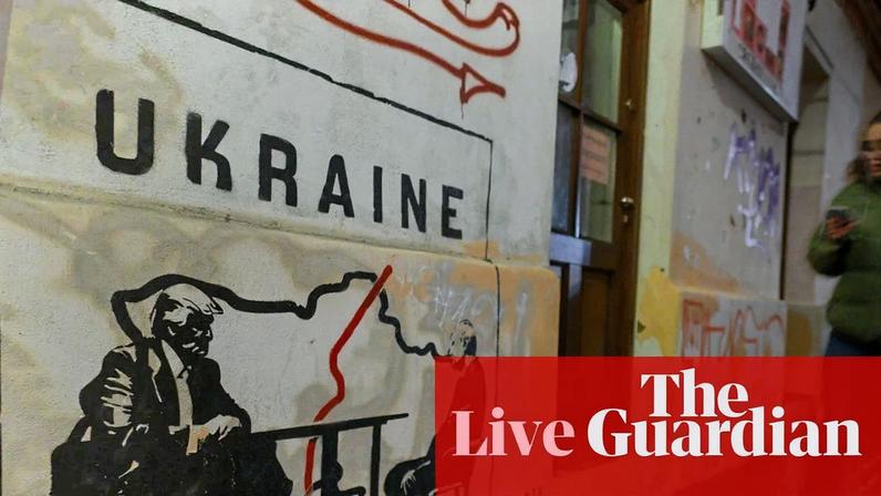 A mural depicting Donald Trump and Vladimir Putin seated at a table next to a map of a divided Ukraine is seen in Krakow, Poland.