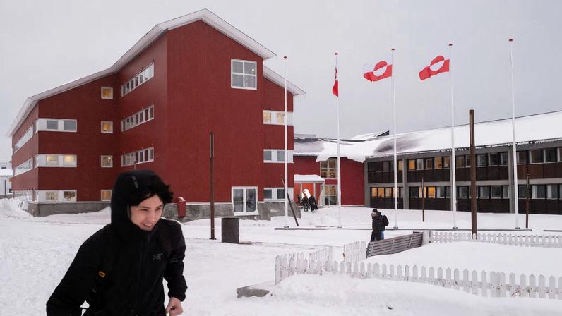 People walk in front of Greenland's parliament Inatsisartut in Nuuk