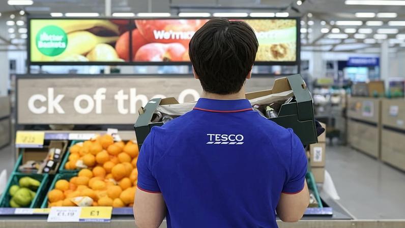A Tesco worker replenishing stock. Tesco has more than 300,000 employees across the UK and Republic of Ireland.