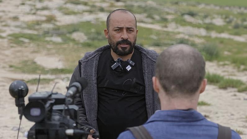 Hamdan Ballal speaks to reporters on 17 February about the attack on his family in Masafer Yatta, West Bank.