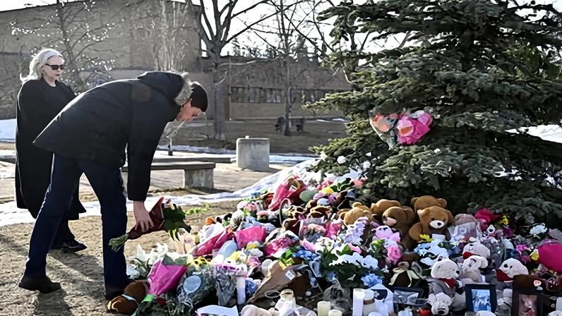 British Columbia premier, David Eby and the minister of public safety, Nina Krieger, at a makeshift memorial for the victims of the Tumbler Ridge school shooting.