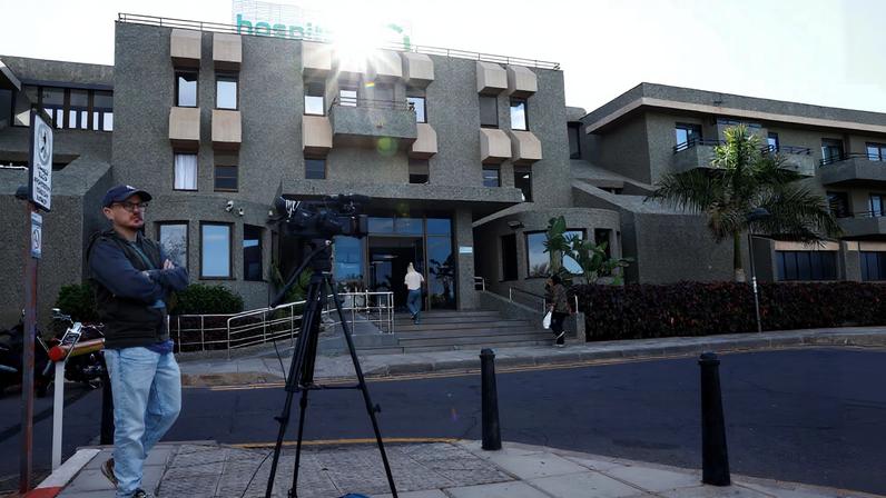 A member of the media works outside the hospital where Norway's King Harald was taken on Tuesday after suffering from an infection and dehydration, according to the royal palace, in Arona, Tenerife island, Spain, February 26, 2026. REUTERS/Borja Suarez