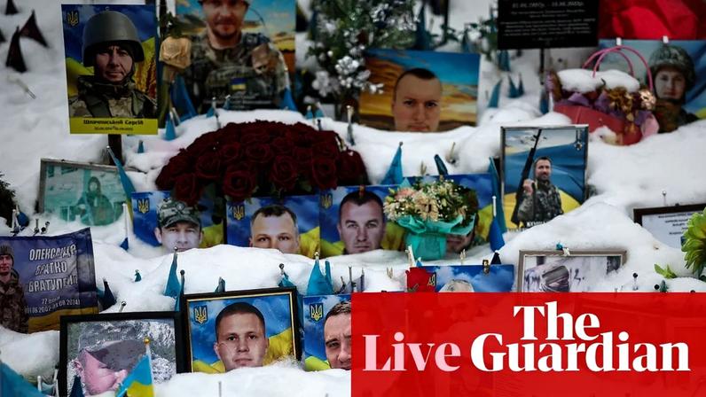 Tributes lie partially covered in snow at a makeshift memorial to fallen Ukrainian and foreign soldiers in Independence Square in Kyiv.