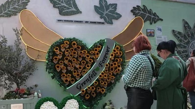 A memorial wall next to Grenfell Tower on the seventh anniversary of the fire.