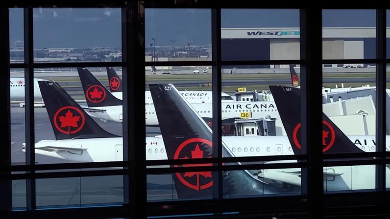 Tails of Air Canada planes are seen at Pearson international airport on 14 August 2025 in Toronto, Canada.