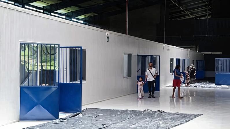 Migrants walk at the Temporary Care Centre for Migrants (Catem) in Paso Canoas, about 300km south of San José, in Puntarenas province, on 27 September 2023.