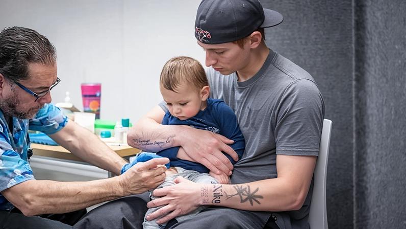 Ethan Turner holds his 14-month-old son, Niko, while he gets the MMR vaccine, in Lubbock, Texas, on 1 March 2025.