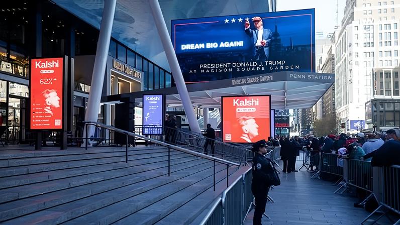 Billboard advertise betting odds for the 2024 US presidential election outside Madison Square Garden in New York City on 27 October 2024.