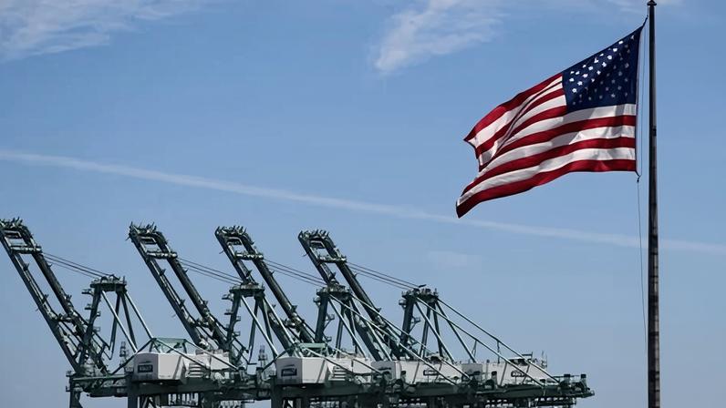 The US flag blows in the wind at the Port of Los Angeles.
