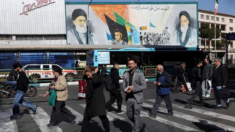 People walk on a street in Tehran