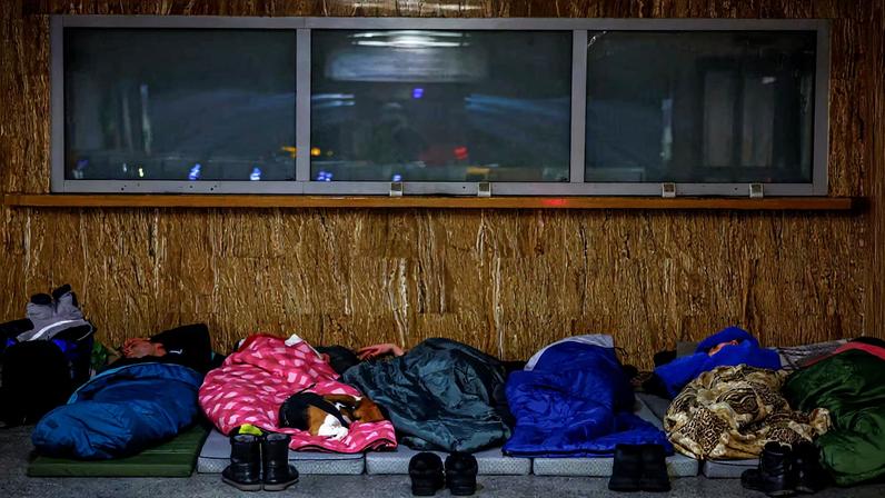 People take shelter inside a metro station during a Russian missile and drone attack, in Kyiv