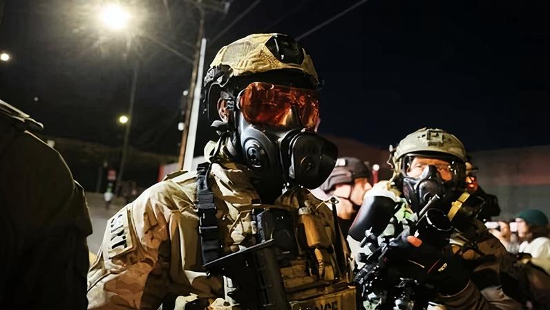 Federal agents attempt to keep protesters back outside a downtown ICE facility on 5 October 2025 in Portland, Oregon.
