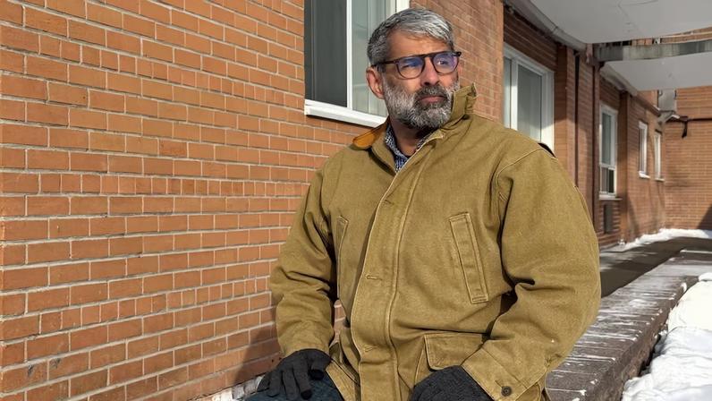 Venezuelan engineer Luis Cabana poses near his apartment in Ottawa