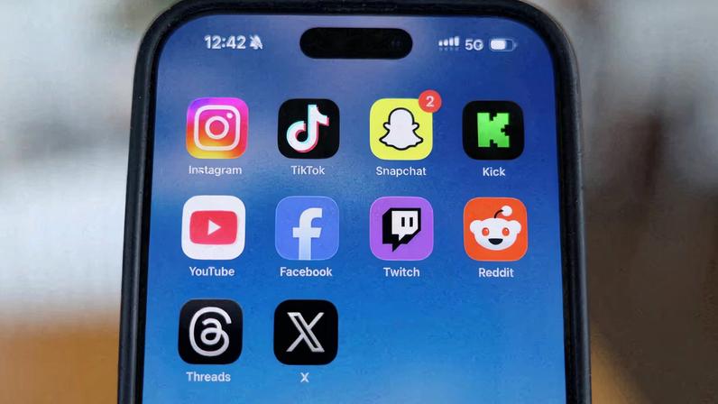 Instagram, TikTok, Snapchat, Kick, YouTube, Facebook, Twitch, Reddit, Threads and X applications are displayed on a mobile phone in this picture illustration taken on December 9, 2025.