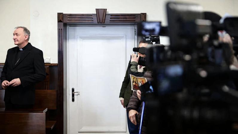 Poland's Catholic diocese of Tarnow Bishop Andrzej Jez stands at a district court before the start of his trial on charges of failing to promptly inform law enforcement about alleged child abuse, in Tarnow