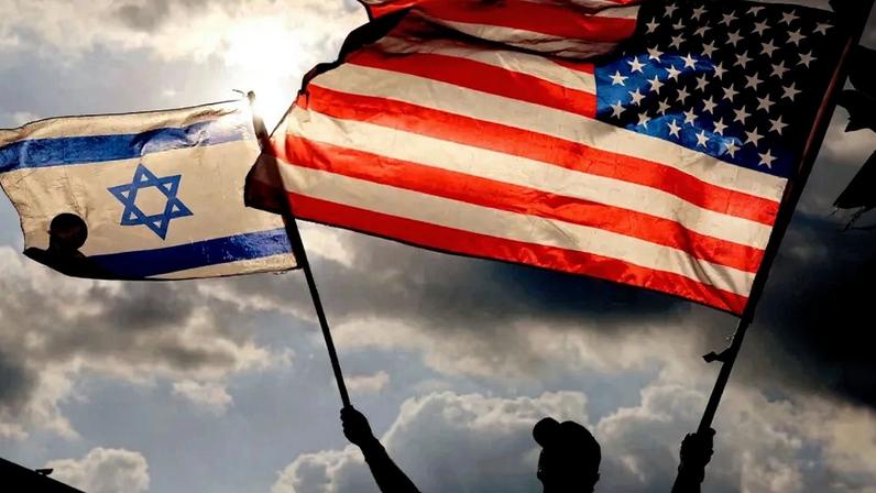 A protester waves U.S. and Israeli flags during a demonstration in Tel Aviv on Sept. 20, 2023.