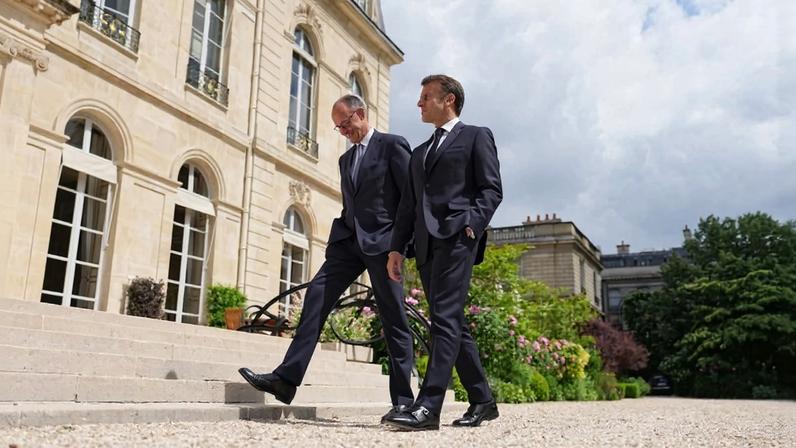 French President Emmanuel Macron (right) takes a walk with new German Chancellor Friedrich Merz in the grounds of Elysee Palace on May 07, 2025 in Paris, France.