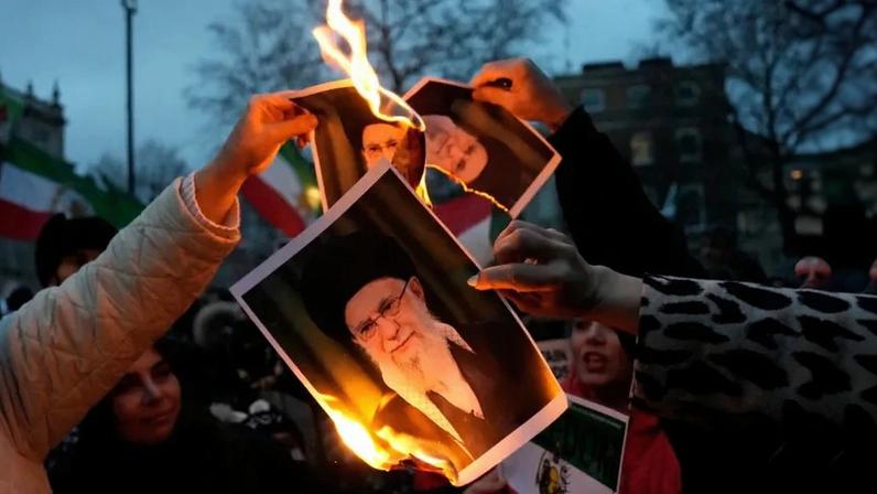 Protestors burn images of Ayatollah Ali Khamenei during a rally held in Solidarity with Iran's Uprising, organised by The national Council of Resistance of Iran, on Whitehall in central London on January 11, 2026, to protest against the Iranian regime's crackdown on internet access and "recognise their right to self-defence against the regime's forces".