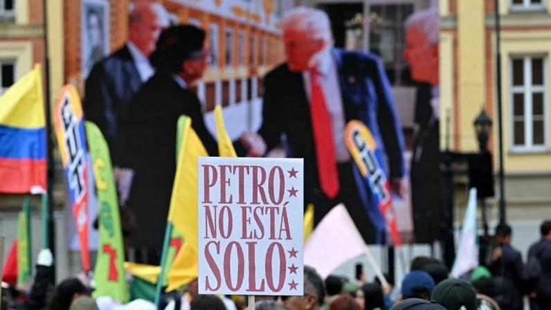 A supporter of Colombian President Gustavo Petro holds a sign that reads "Petro is not alone" during a rally in support of his visit to the United States for a meeting with U.S. President Donald Trump, in Bogotá.
