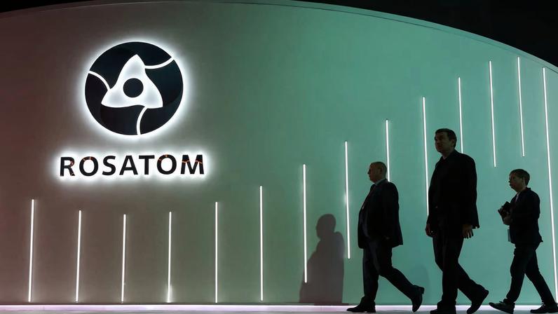 Men walk past an exhibition stand of Russia's State Atomic Energy Corporation Rosatom at the Russian Energy Week international forum in Moscow, Russia, October 15, 2025. REUTERS/Ramil Sitdikov
