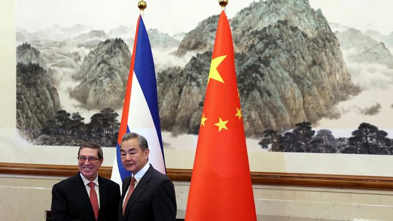 Chinese Foreign Minister Wang Yi and Cuban Foreign Minister Bruno Rodriguez Parrilla shake hands before their meeting at the Diaoyutai State Guesthouse in Beijing, China May 12, 2025.