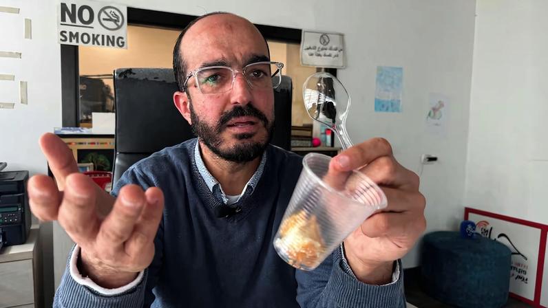 Samer Khaweireh, 45, a Palestinian journalist and former prisoner, explains the amount of food he was given daily while in Israeli detention, during an interview with Reuters in Nablus
