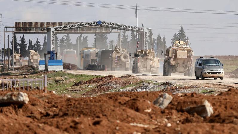 U.S. military vehicles escort buses transporting Islamic State detainees from Syria to Iraq, according to a security source from the Syrian Democratic Forces, in Qamishli, Syria, February 8, 2026.
