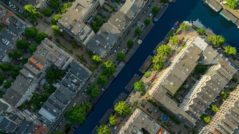 Research reveals a strong disparity in the amount of heat-mitigating tree cover within nine cities across the globe, with wealthy neighborhoods benefitting from shade the most. Amsterdam, pictured here, has a distinct pattern of less shade in lower-income areas.