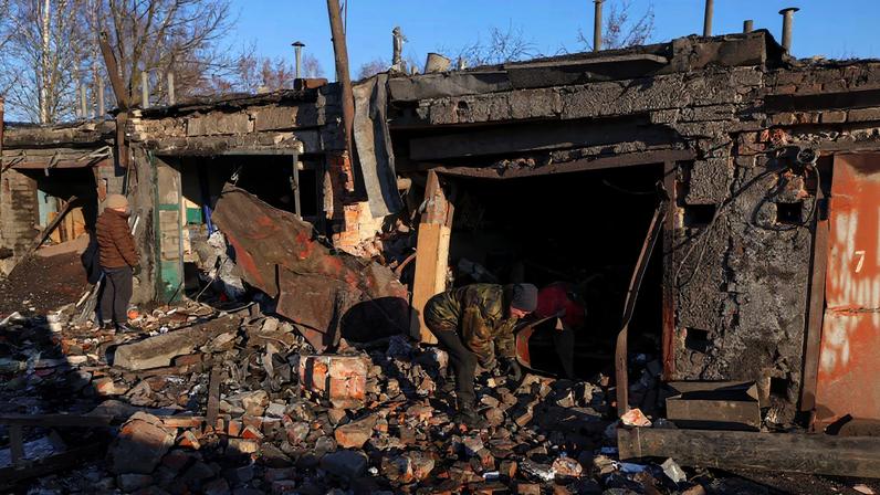 Residents remove debris from their car garages damaged by a Russian missile strike, amid Russia's attack on Ukraine, in Chernihiv, Ukraine January 5, 2026. REUTERS/Maksym Kishka