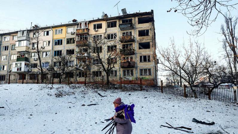 A woman, who is a school employee, walks near the site of an apartment building hit by a Russian drone strike, amid Russia's attack on Ukraine, in Kyiv, Ukraine February 3, 2026.