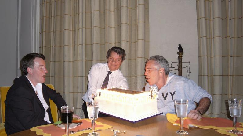 Peter Mandelson sits with late financier and convicted sex offender Jeffrey Epstein, as he blows out the candles on a cake, in an undated photograph released by the Department of Justice in Washington, D.C., U.S., on December 19, 2025 as part of a trove of documents from its investigations into Epstein.