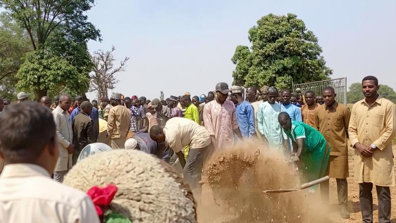 People dig graves with shovels after a deadly attack by an armed gang in Katsina, Nigeria, February 4, 2026, in this screengrab from video.
