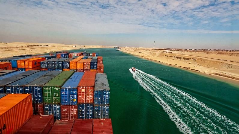 Loaded containers stacked on top of a cargo ship sail through the Suez Canal near Egypt on Jan. 20, 2017.