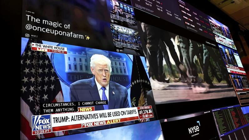 A press conference on tariffs by U.S. President Donald Trump is displayed on a television as traders work on the floor of the New York Stock Exchange during afternoon trading in New York City on Feb. 20.